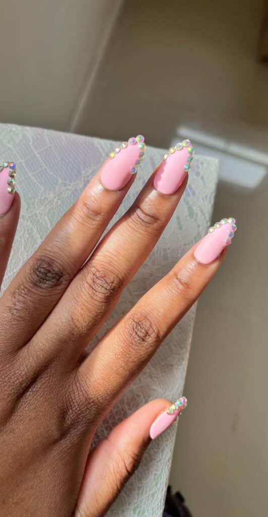 Matte pink oval nails with diamond tips
